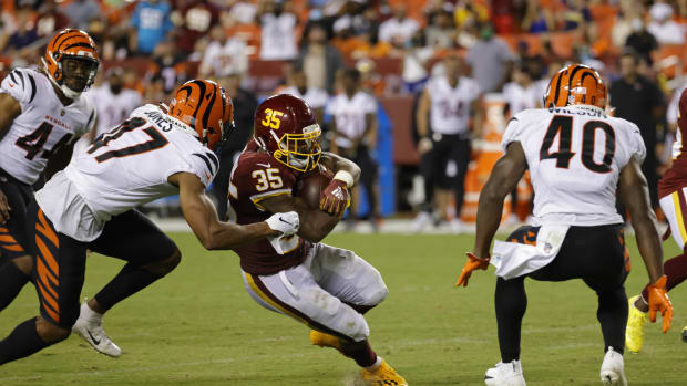 Aug 20, 2021; Landover, Maryland, USA; Washington Football Team running back Jaret Patterson (35) carries the ball as Cincinnati Bengals linebacker Keandre Jones (47) chases in the fourth quarter at FedExField. Mandatory Credit: Geoff Burke-USA TODAY Sports