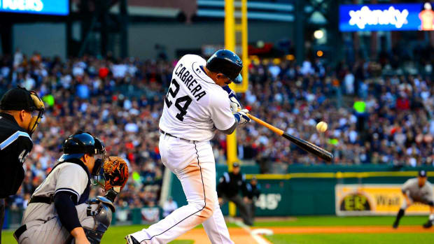 Miguel Cabrera of the Detroit Tigers swings and hits a ball.