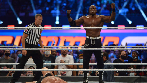 WWE Wrestler Bobby Lashley posing over his opponent, Goldberg, at SummerSlam 2021.