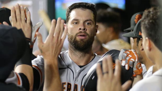 Aug 24, 2021; New York City, New York, USA; San Francisco Giants first baseman Brandon Belt (9) celebrates his solo home run against the New York Mets in the dugout with teammates during the fourth inning at Citi Field.