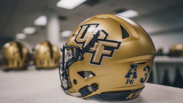 UCF Gold Helmets on Table