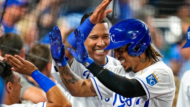Sep 1, 2021; Kansas City, Missouri, USA; Kansas City Royals designated hitter Adalberto Mondesi (27) is congratulated by catcher Salvador Perez (13) and shortstop Nicky Lopez (8) after hitting a home run against the Cleveland Indians during the fourth inning at Kauffman Stadium. Mandatory Credit: Jay Biggerstaff-USA TODAY Sports