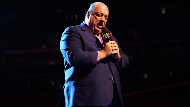 Paul Heyman in the ring with a microphone