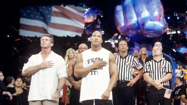Vince McMahon and The Rock listen to the national anthem during WWE's first show after 9/11