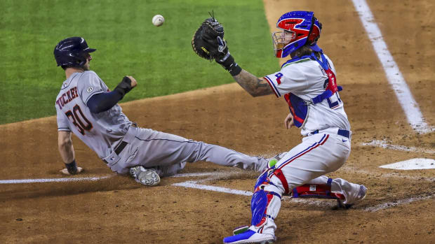Sep 15, 2021; Arlington, Texas, USA; Houston Astros right fielder Kyle Tucker (30) scores ahead of the tag by Texas Rangers catcher Jonah Heim (28) during the fourth inning at Globe Life Field.