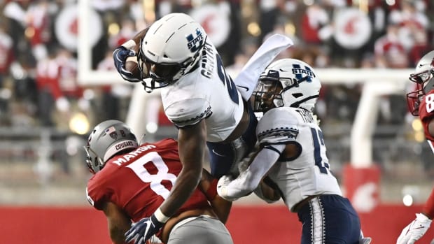 Sep 4, 2021; Pullman, Washington, USA; Utah State Aggies running back John Gentry (2) is up ended by Washington State Cougars defensive back Armani Marsh (8) in the second half at Gesa Field at Martin Stadium. The Aggies26-23. Mandatory Credit: James Snook-USA TODAY Sports