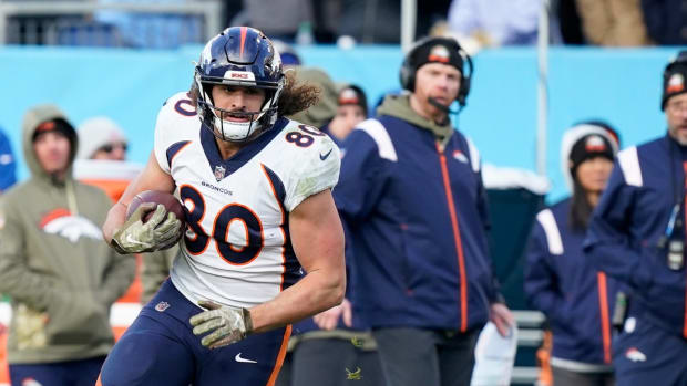 Denver Broncos tight end Greg Dulcich (80) is tackled by Tennessee Titans safety Joshua Kalu (28) during the fourth quarter at Nissan Stadium.