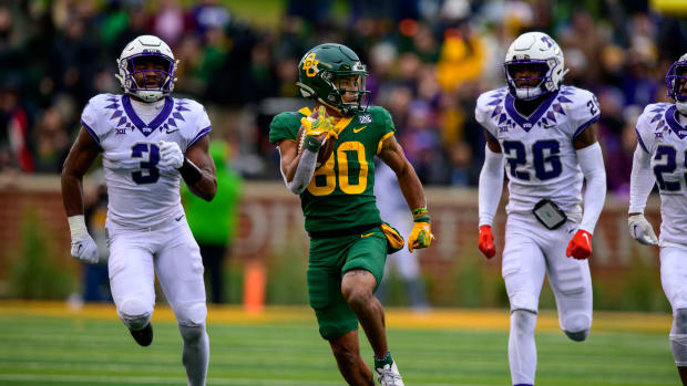Nov 19, 2022; Waco, Texas, USA; Baylor Bears wide receiver Monaray Baldwin (80) runs away from TCU Horned Frogs safety Mark Perry (3) and safety Millard Bradford (28) during the second half at McLane Stadium. Mandatory Credit: Jerome Miron-USA TODAY Sports