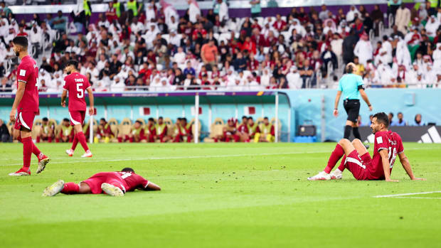 Players from Qatar pictured looking dejected during their 3-1 loss to Senegal at the 2022 FIFA World Cup