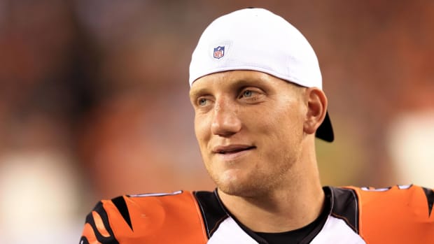 Former Bengals linebacker A.J. Hawk looks on from the sidelines during a game.