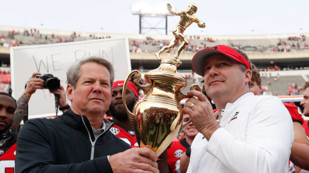 Georgia Governor Brian Kemp presents Georgia head coach Kirby Smart with the Governors Cup after a NCAA college football game between Georgia Tech and Georgia in Athens, Ga., on Saturday, Nov. 26, 2022. Georgia won 37-14.