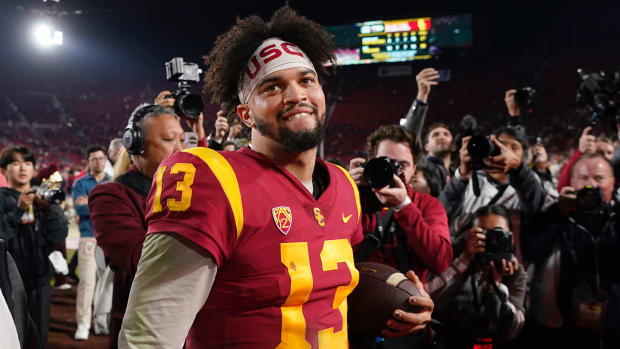 Caleb Williams smiles surrounded by cameras after USC defeated Notre Dame on Saturday, Nov. 26, 2022, in Los Angeles.