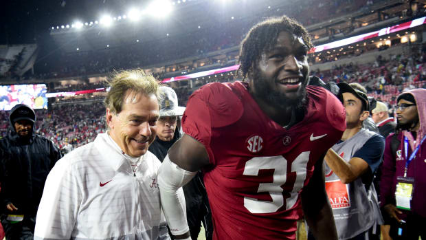Alabama Crimson Tide head coach Nick Saban and linebacker Will Anderson Jr. (31) share a smile as they leave the field after defeating the Auburn Tigers at Bryant-Denny Stadium. Alabama won 49-27.