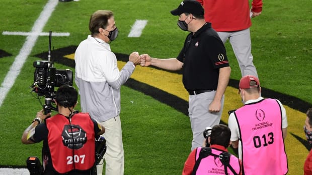 Alabama head coach Nick Saban and Ohio State head coach Ryan Day embrace before the 2021 National Championship Game.