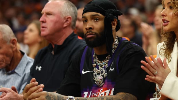 Wide receiver Odell Beckham Jr. watches a Suns game from courtside seats.