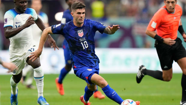 Christian Pulisic of the United States runs with the ball during the World Cup group B soccer match against England.