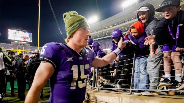 Nov 26, 2022; Fort Worth, Texas, USA; TCU Horned Frogs quarterback Max Duggan (15) high fives fans as he leaves the field following a game against the Iowa State Cyclones during second half at Amon G. Carter Stadium. TCU won 62-14. Mandatory Credit: Raymond Carlin III-USA TODAY Sports