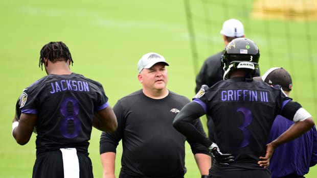 Baltimore Ravens offensive coordinator Greg Roman (center) talks to quarterbacks Lamar Jackson (8) and Robert Griffin III (3) during minicamp at Under Armour Performance Center.