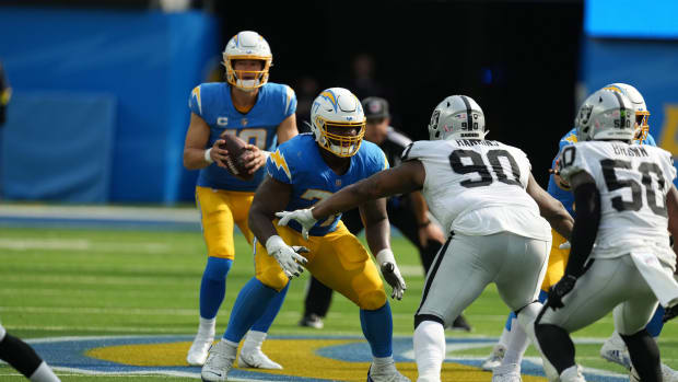 Sep 11, 2022; Inglewood, California, USA; Los Angeles Chargers guard Zion Johnson (77) blocks Las Vegas Raiders defensive tackle Johnathan Hankins (90) as Chargers quarterback Justin Herbert (10) drops back to pass in the second half at SoFi Stadium. Mandatory Credit: Kirby Lee-USA TODAY Sports