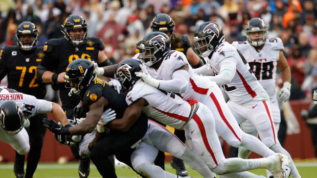 Nov 27, 2022; Landover, Maryland, USA; Washington Commanders running back Brian Robinson Jr. (8) is tac led by a group of Atlanta Falcons during the second quarter at FedExField. Mandatory Credit: Geoff Burke-USA TODAY Sports