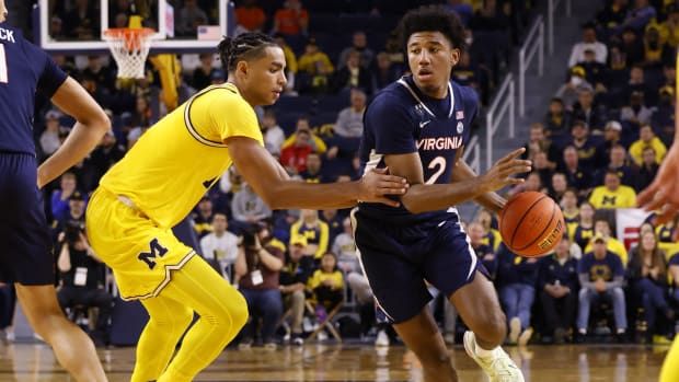 Virginia Cavaliers guard Reece Beekman (2) dribbles defended by Michigan Wolverines guard Jett Howard (13) in the second half at Crisler Center.