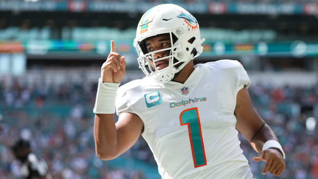 Dolphins quarterback Tua Tagovailoa (1) celebrates his touchdown pass to tight end Durham Smythe (not pictured) during the first half against the Texans.
