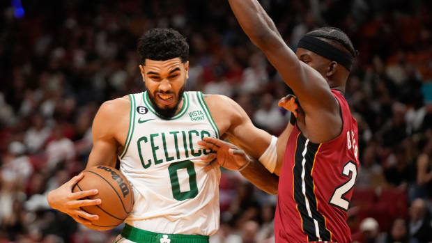Oct 21, 2022; Miami, Florida, USA; Boston Celtics forward Jayson Tatum (0) dribbles past Miami Heat forward Jimmy Butler (22) during the first quarter at FTX Arena.