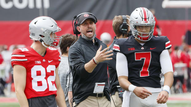 Wide receivers coach Brian Hartline talks to Team Brutus wide receiver Sam Wiglusz (82) and quarterback C.J. Stroud (7) during the Ohio State Buckeyes football spring game at Ohio Stadium in Columbus on Saturday, April 17, 2021. Ohio State Football Spring Game