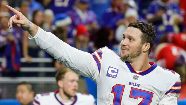 Bills quarterback Josh Allen points to the stands after beating the Lions.