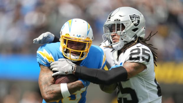Sep 11, 2022; Inglewood, California, USA; Los Angeles Chargers wide receiver Keenan Allen (13) tries to break free from the grasp of Las Vegas Raiders safety Tre'von Moehrig (25) in the first half at SoFi Stadium. Mandatory Credit: Kirby Lee-USA TODAY Sports