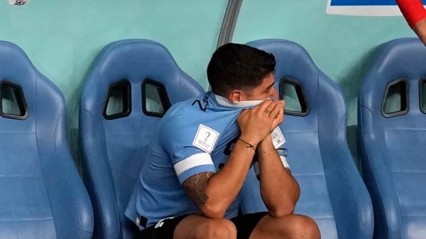Uruguay’s Luis Suarez sits on the bench during the World Cup group H soccer match against Ghana.