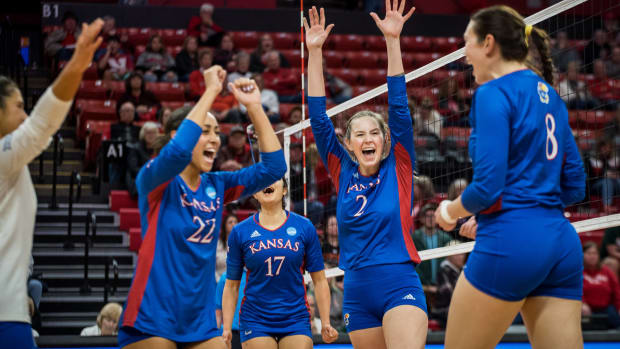 Kansas Jayhawks players celebrate after scoring a point in a match against the Miami Hurricanes as part of the first round of the NCAA Women's Volleyball tournament on December 1, 2022.