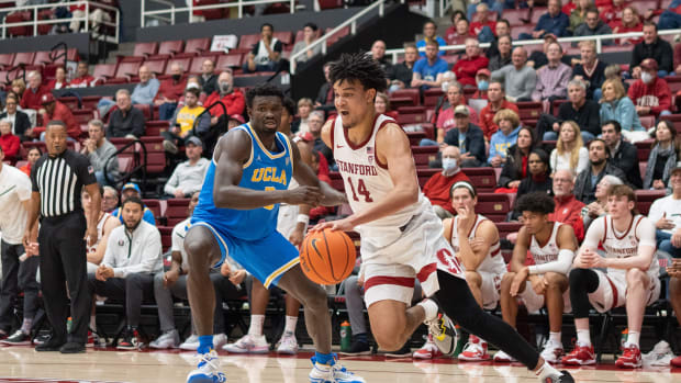 Stanford, California, USA; Stanford Cardinal forward Spencer Jones (14) drives the ball during the second half against UCLA Bruins forward Adem Bona (3) at Maples Pavilion