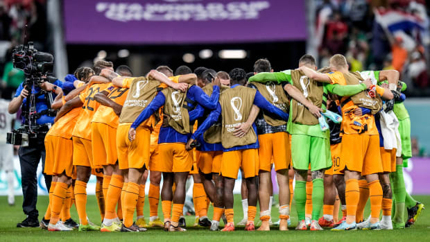 Netherlands players huddle up to celebrate their team victory at the end of the World Cup group A soccer match against Qatar.