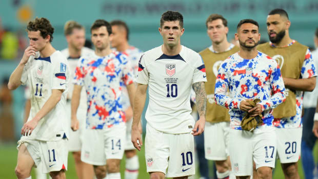 Players of the United States salute supporters at the end of the World Cup round of 16 soccer match against the Netherlands.