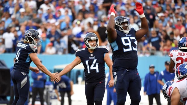 Tennessee Titans place kicker Randy Bullock (14) slaps hands with punter Ryan Stonehouse (4) after a field goal during the first half against the New York Giants at Nissan Stadium.
