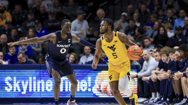 Dec 3, 2022; Cincinnati, Ohio, USA; West Virginia Mountaineers guard Joe Toussaint (5) controls the ball against Xavier Musketeers guard Souley Boum (0) in the first half at Cintas Center.