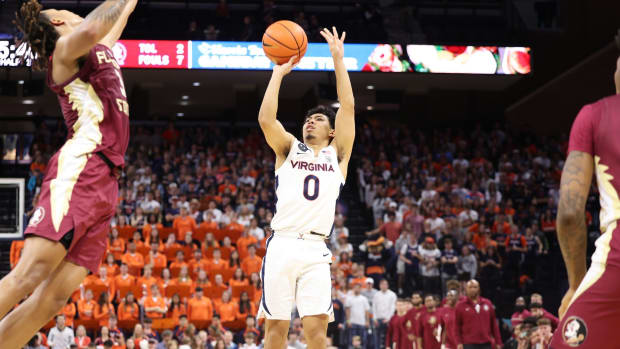 Kihei Clark attempts a three-pointer during the Virginia men's basketball game against Florida State at John Paul Jones Arena.