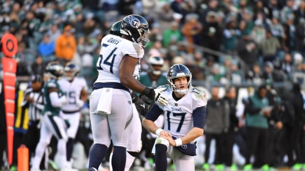 Tennessee Titans quarterback Ryan Tannehill (17) is helped up by guard Nate Davis (64) against the Philadelphia Eagles during the fourth quarter at Lincoln Financial Field.