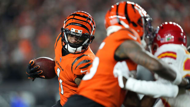 Dec 4, 2022; Cincinnati, Ohio, USA; Cincinnati Bengals wide receiver Ja'Marr Chase (1) runs for a first down as Cincinnati Bengals wide receiver Tee Higgins (85) blocks in the fourth quarter of a Week 13 NFL game at Paycor Stadium. Mandatory Credit: Kareem Elgazzar-USA TODAY Sports