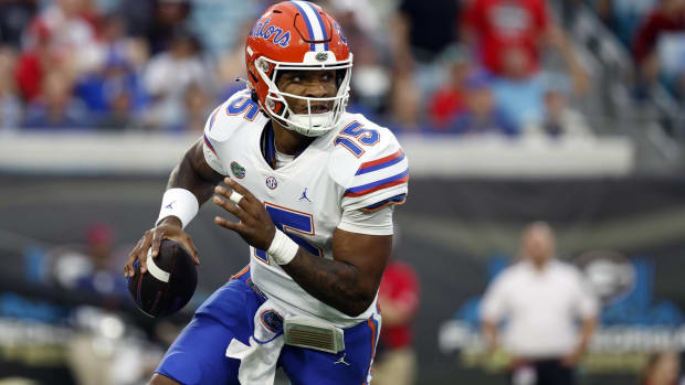 Florida quarterback Anthony Richardson rolls out to throw a pass in a game vs. Georgia.