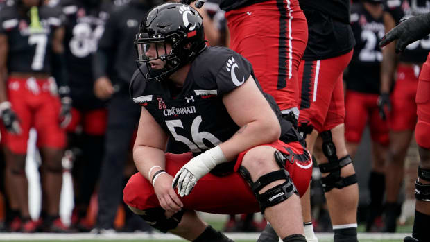 Cincinnati offensive lineman Jake Renfro (56) stands over the ball during the first half of an NCAA college football game against Miami (Ohio) Saturday, Sept. 4, 2021, in Cincinnati. (AP Photo/Jeff Dean)