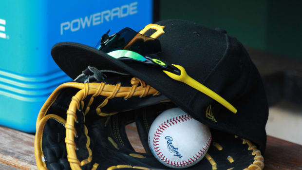 Jul 28, 2018; Pittsburgh, PA, USA; A Pittsburgh Pirates glove and cap are seen in the dugout during a game against the New York Mets at PNC Park.