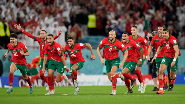 Morocco players celebrate their World Cup last-16 win over Spain