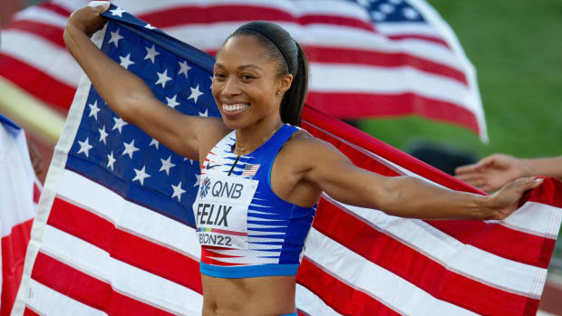 Allyson Felix holds an American flag after competing in the mixed 4x400 meter relay at the 2022 World Athletics Championships.