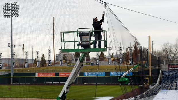 Billy Norghey with J. Hicks Sports Installation works on installing the new retractable protective netting at Aces ballpark to protect baseball fans from getting hit by a foul ball during Aces games.