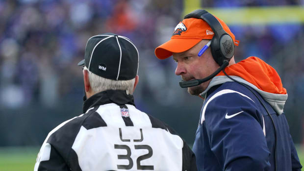 Denver Broncos head coach Nathaniel Hackett talks with line judge Jeff Bergman (32) on the sidelines in the fourth quarter against the Baltimore Ravens at M&T Bank Stadium.