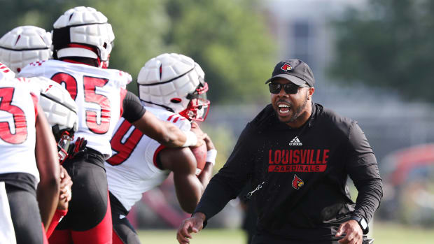U of L running backs coach De'Rail Sims conducts drills during practice on fan day outside Cardinal Stadium in Louisville, Ky. on Aug. 8, 2021. Uofl13 Sam