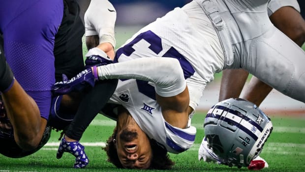 Dec 3, 2022; Arlington, TX, USA; Kansas State Wildcats cornerback Julius Brents (23) loses his helmet as he tackles TCU Horned Frogs wide receiver Quentin Johnston (1) at AT&T Stadium. Mandatory Credit: Jerome Miron-USA TODAY Sports