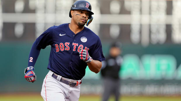Red Sox shortstop Xander Bogaerts rounds the bases after hitting a home run against the Athletics.